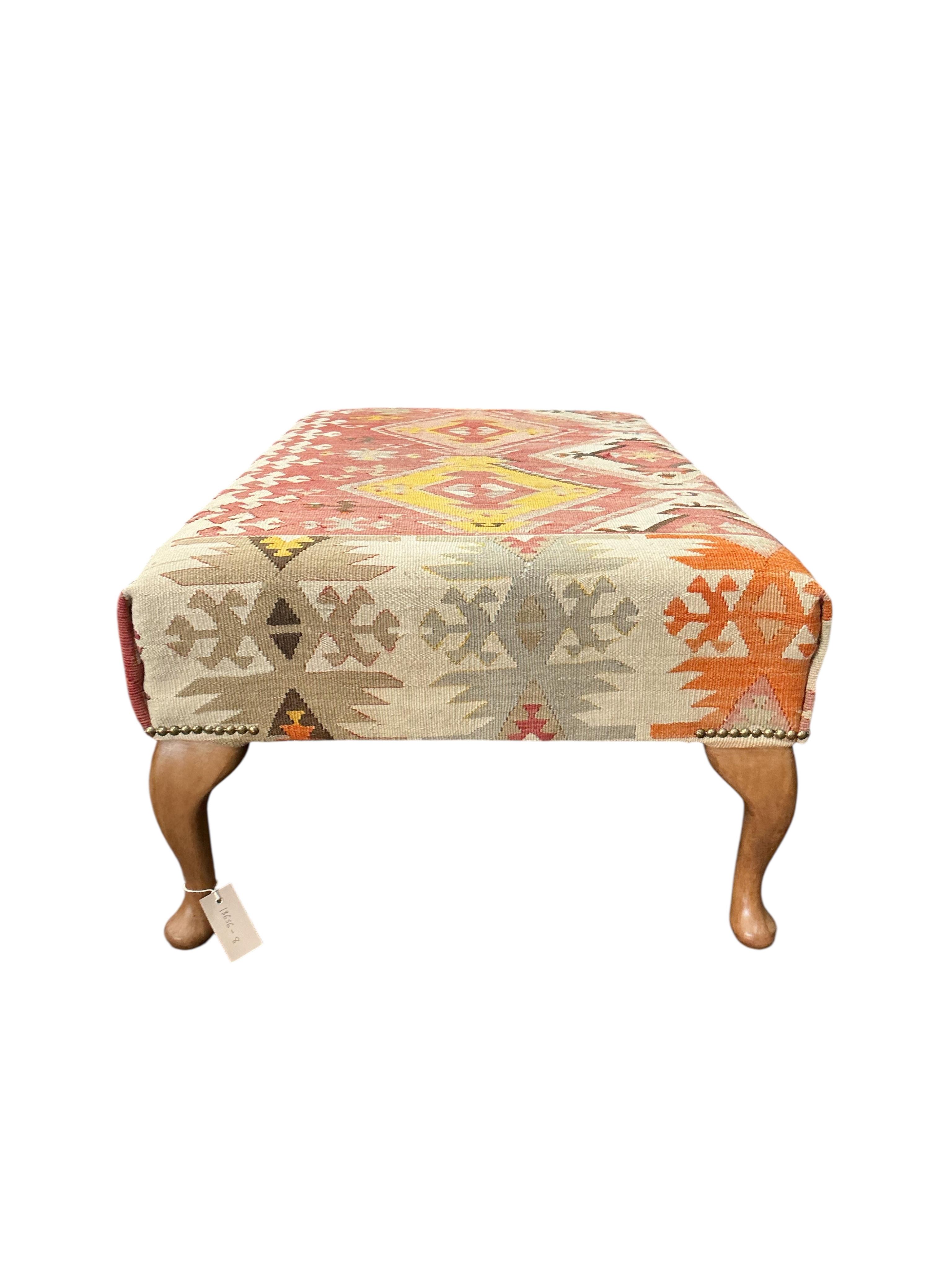 A rectangular footstool with Kilim upholstered seat, width 110cm, depth 63cm, height 40cm